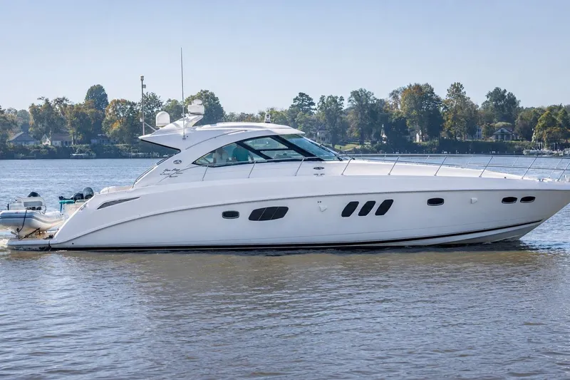 Slide: The Image of 2012 Sea Ray Sundancer 540 yacht cruising on a calm river. - 57