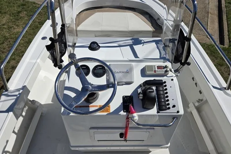 Slide: The Image of 2018 Parker 1801 Center Console boat dashboard with steering wheel and controls. - 11