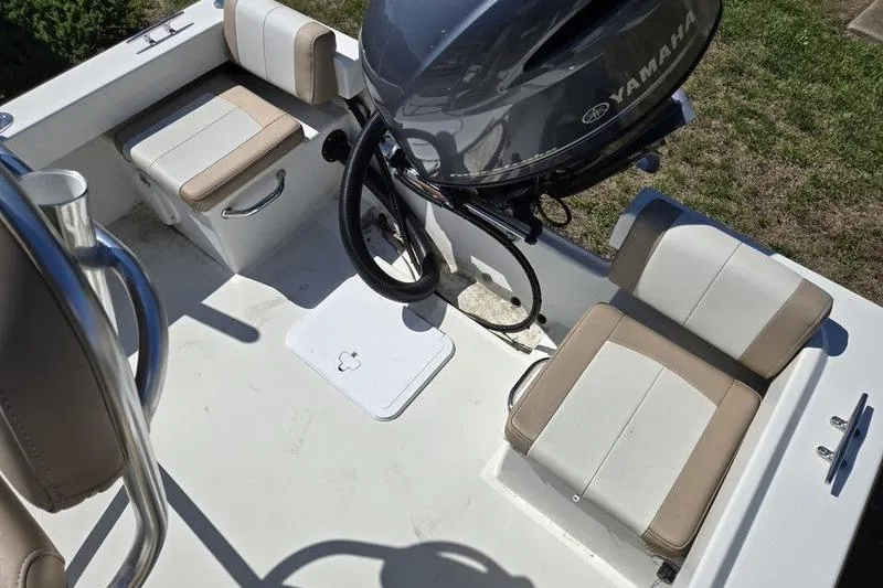 Slide: The Image of 2018 Parker 1801 Center Console boat interior with Yamaha engine and cushioned seating. - 6
