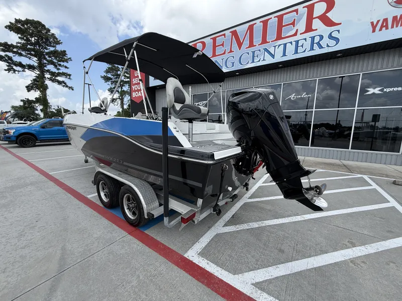 Slide: The Image of 2023 Starcraft SXV-211 boat on trailer outside boating center. - 10