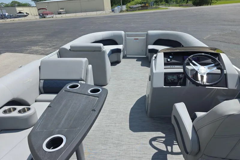 Slide: The Image of 2022 Bennington L 21 L-Bench pontoon boat interior with steering console and seating. - 12