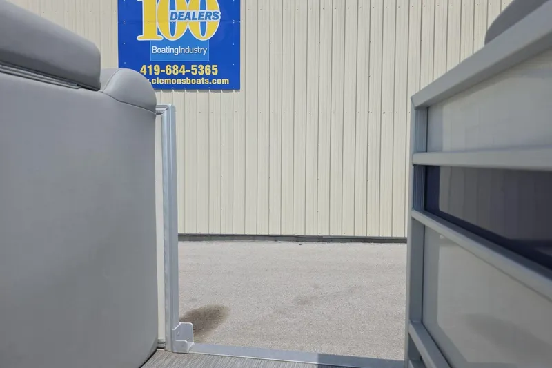 Slide: The Image of 2022 Bennington L 21 L-Bench pontoon boat at dealership, exterior view. - 14
