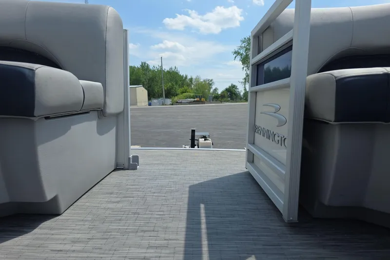 Slide: The Image of 2022 Bennington L 21 L-Bench pontoon boat interior with open gate and seating. - 15