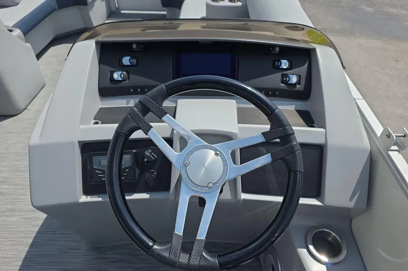Slide: The Image of Steering console of 2022 Bennington L 21 L-Bench pontoon boat with modern controls. - 17