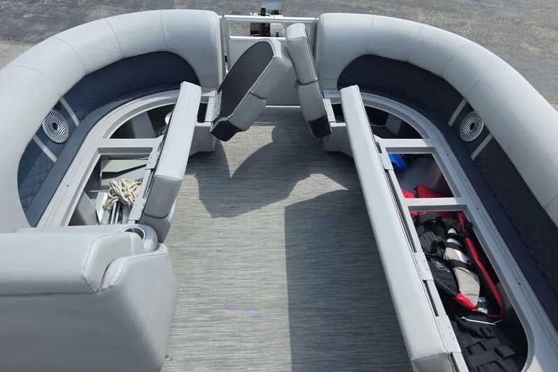 Slide: The Image of 2022 Bennington L 21 L-Bench pontoon boat interior with storage compartments open. - 6