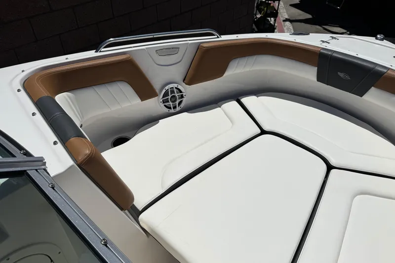 Slide: The Image of 2023 Chaparral 23 SSi boat interior with cushioned seating and speaker. - 15