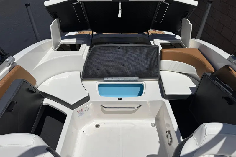 Slide: The Image of 2023 Chaparral 23 SSi boat interior with open storage compartments and seating. - 20