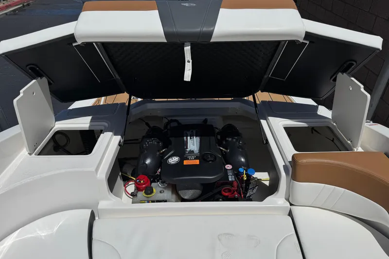 Slide: The Image of 2023 Chaparral 23 SSi boat engine compartment with open hatches, showcasing modern design. - 21