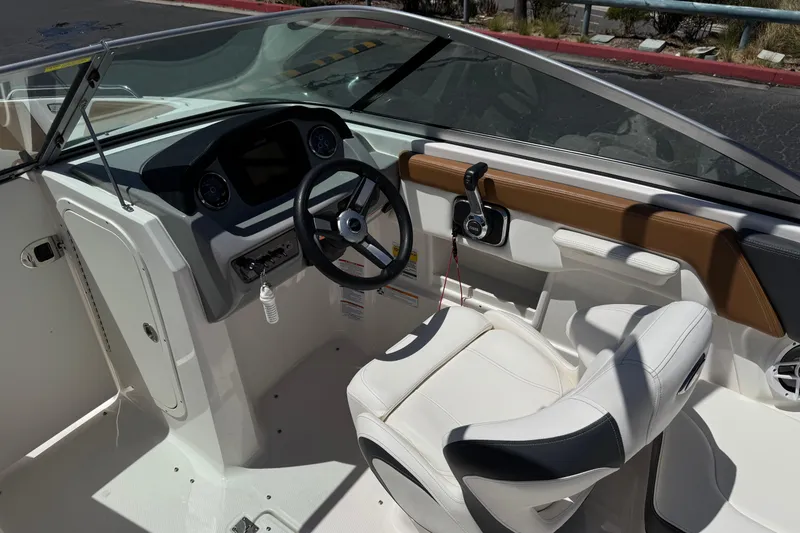 Slide: The Image of 2023 Chaparral 23 SSi boat interior with steering wheel and dashboard controls. - 29