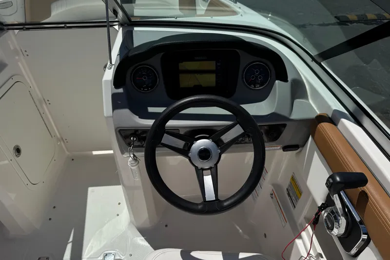 Slide: The Image of 2023 Chaparral 23 SSi boat dashboard with steering wheel and control panel. - 30