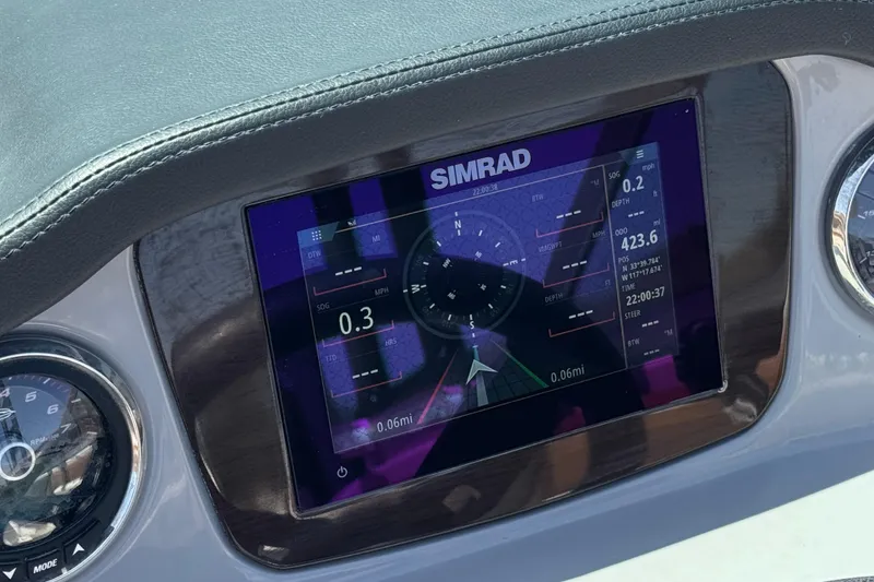 Slide: The Image of Dashboard of 2023 Chaparral 23 SSi boat featuring Simrad navigation display. - 32