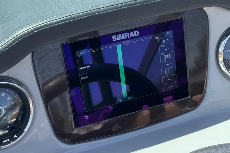 Slide: The Image of Simrad display on 2023 Chaparral 23 SSi boat dashboard, showing navigation data. - 33