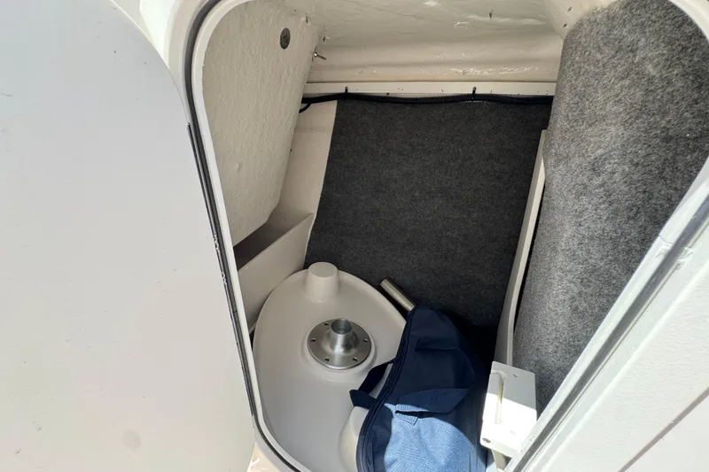 Slide: The Image of Interior of 2023 Chaparral 23 SSi boat, featuring compact storage space. - 35