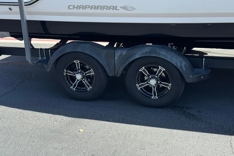 Slide: The Image of 2023 Chaparral 23 SSi boat trailer with dual black alloy wheels. - 36