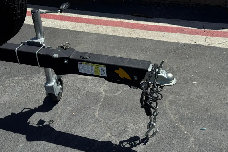 Slide: The Image of Trailer hitch of a 2023 Chaparral 23 SSi boat on asphalt pavement. - 37