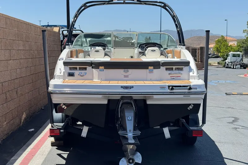 Slide: The Image of 2023 Chaparral 23 SSi boat, rear view, parked outdoors on a sunny day. - 4