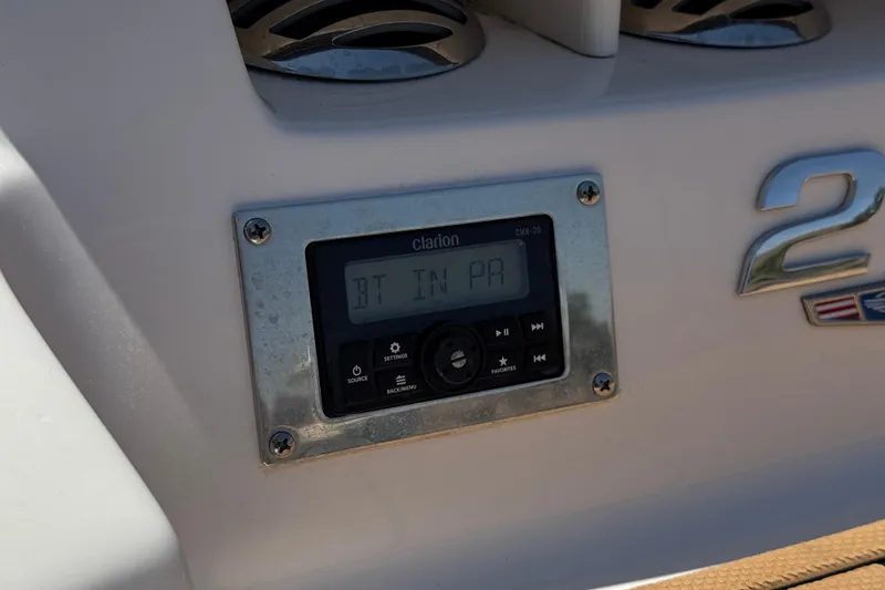 Slide: The Image of Clarion audio system on 2023 Chaparral 23 SSi boat dashboard. - 8