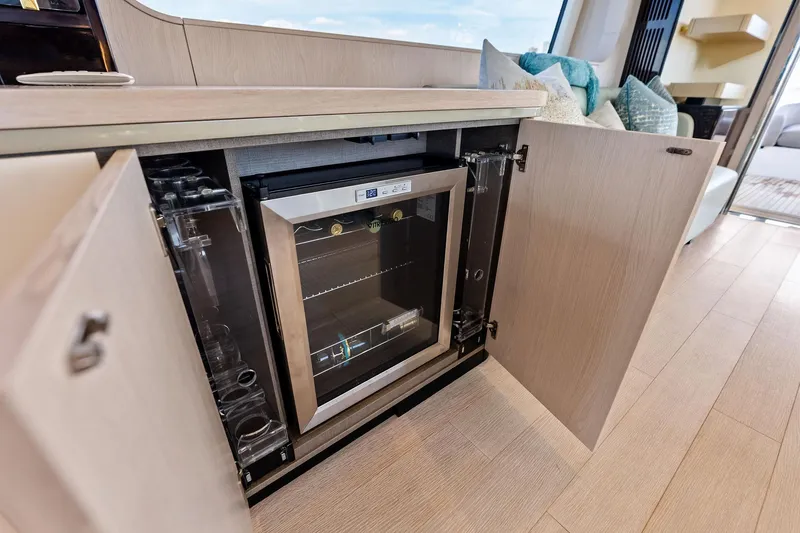 Slide: The Image of Luxury interior of 2021 Azimut Fly 78 yacht featuring a built-in wine cooler. - 17