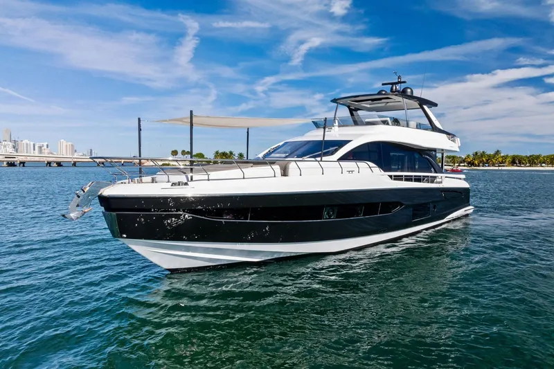 Slide: The Image of Luxury 2021 Azimut Fly 78 yacht cruising on clear blue waters under a sunny sky. - 2