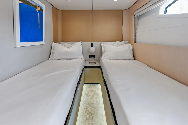 Slide: The Image of Luxurious twin cabin interior on 2021 Azimut Fly 78 yacht, featuring modern decor and artwork. - 53