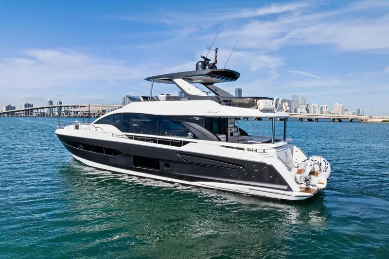 Slide: The Image of Luxury 2021 Azimut Fly 78 yacht cruising near city skyline on a sunny day. - 68