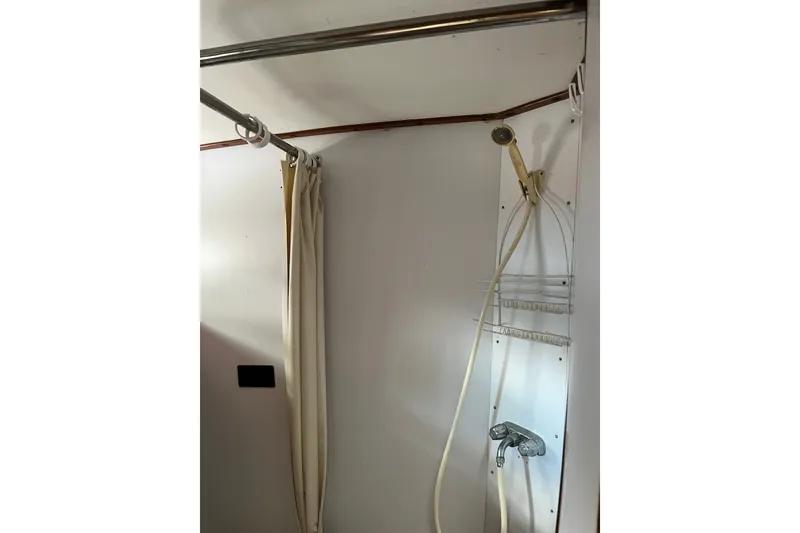 Slide: The Image of Shower area in 1980 Cheoy Lee 43 Pilot House yacht with curtain and handheld showerhead. - 73