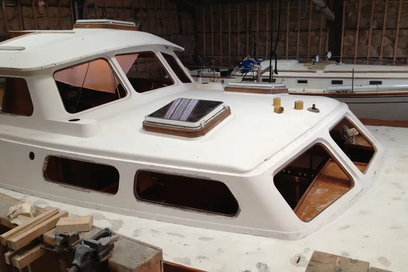 Slide: The Image of 1980 Cheoy Lee 43 Pilot House yacht under restoration in a workshop. - 94