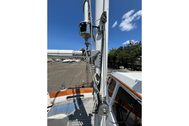 Slide: The Image of 1980 Cheoy Lee 43 Pilot House sailboat mast and rigging under clear blue sky. - 15
