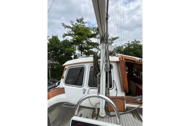 Slide: The Image of 1980 Cheoy Lee 43 Pilot House sailboat deck with steering wheel and cabin entrance. - 16