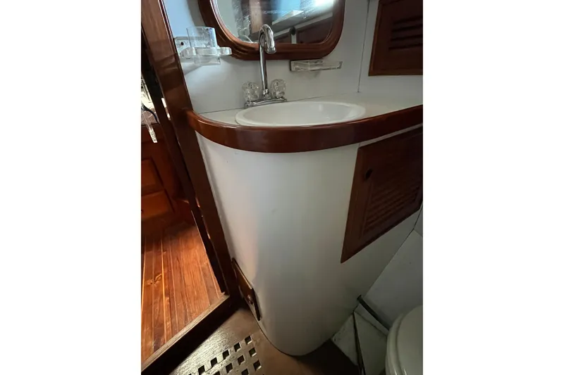Slide: The Image of 1980 Cheoy Lee 43 Pilot House bathroom with sink and wooden cabinetry. - 69