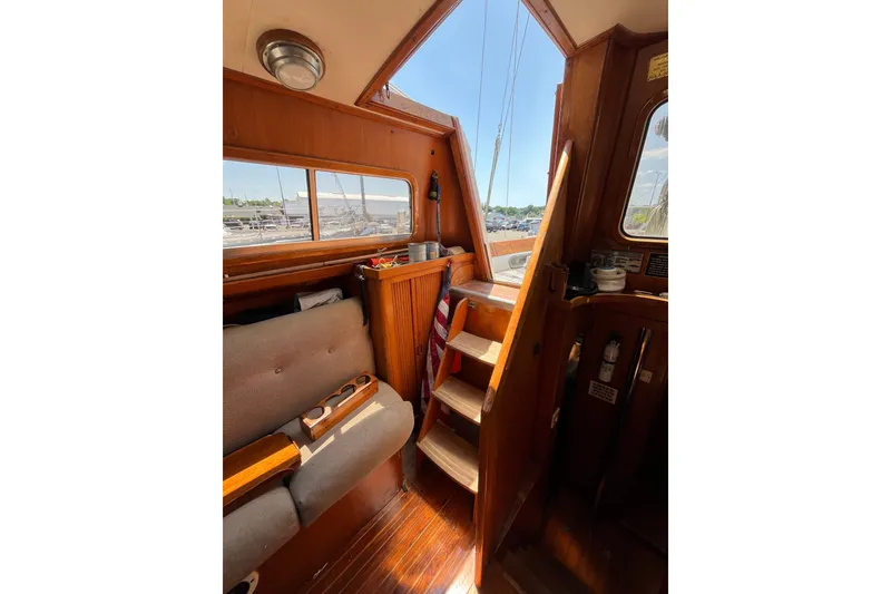 Slide: The Image of Interior of 1980 Cheoy Lee 43 Pilot House with wooden stairs and seating area. - 37