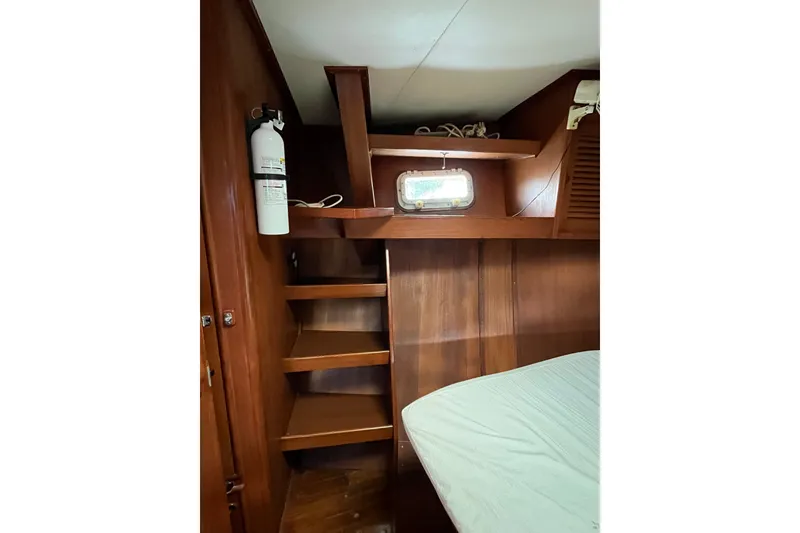 Slide: The Image of Interior of 1980 Cheoy Lee 43 Pilot House with wooden shelves and fire extinguisher. - 61