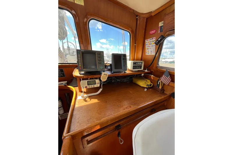 Slide: The Image of 1980 Cheoy Lee 43 Pilot House interior with navigation equipment and wooden finish. - 42