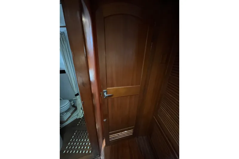 Slide: The Image of Wooden interior door on 1980 Cheoy Lee 43 Pilot House yacht, leading to bathroom. - 58