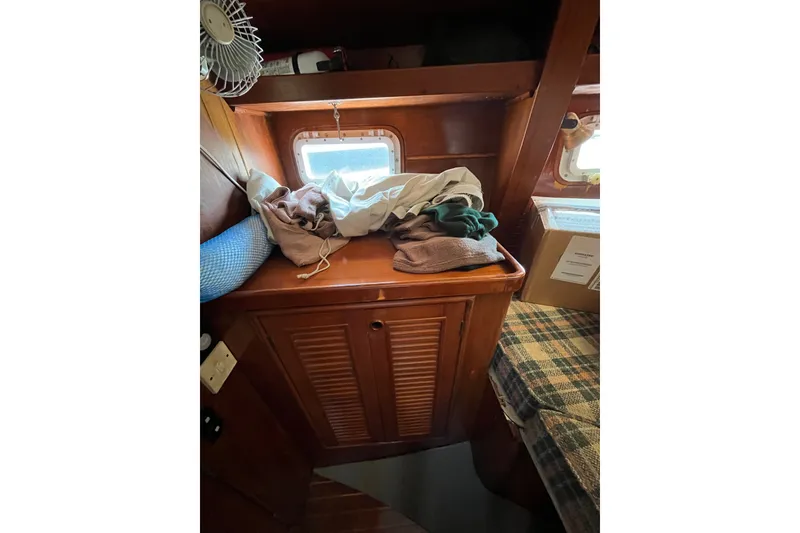 Slide: The Image of Interior of 1980 Cheoy Lee 43 Pilot House with wooden cabinetry and window. - 85