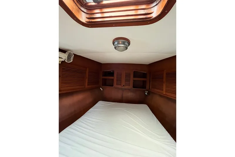 Slide: The Image of Interior cabin of 1980 Cheoy Lee 43 Pilot House with wooden paneling and skylight. - 60