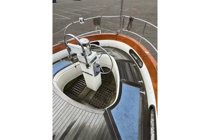 Slide: The Image of 1980 Cheoy Lee 43 Pilot House cockpit with steering wheel and wooden accents. - 20