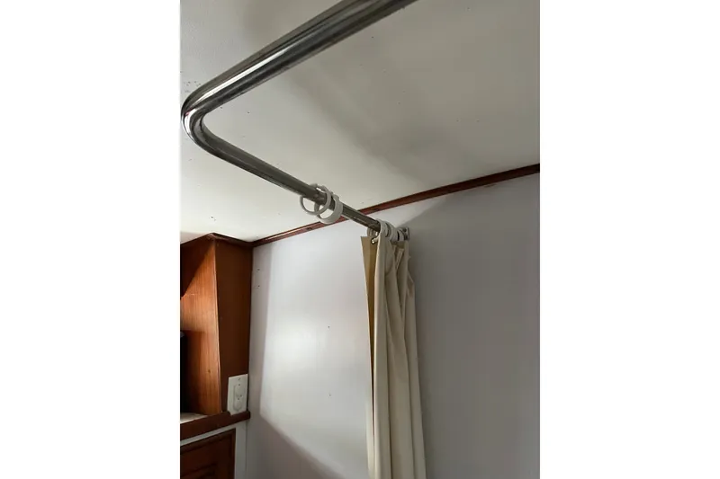 Slide: The Image of Curtain rod and beige curtain inside 1980 Cheoy Lee 43 Pilot House boat. - 70