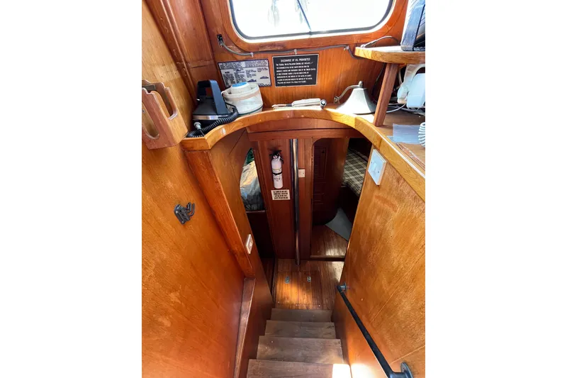 Slide: The Image of Interior of 1980 Cheoy Lee 43 Pilot House with wooden stairs and nautical equipment. - 82