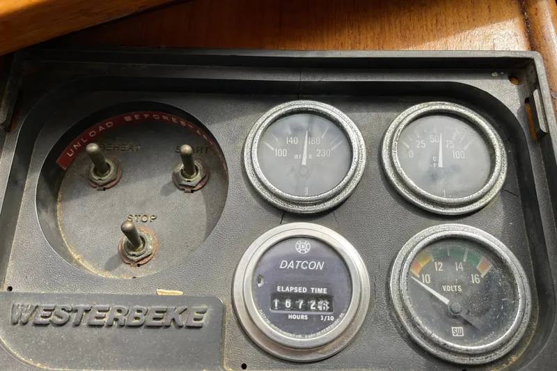 Slide: The Image of Instrument panel of a 1980 Cheoy Lee 43 Pilot House with gauges and switches. - 33