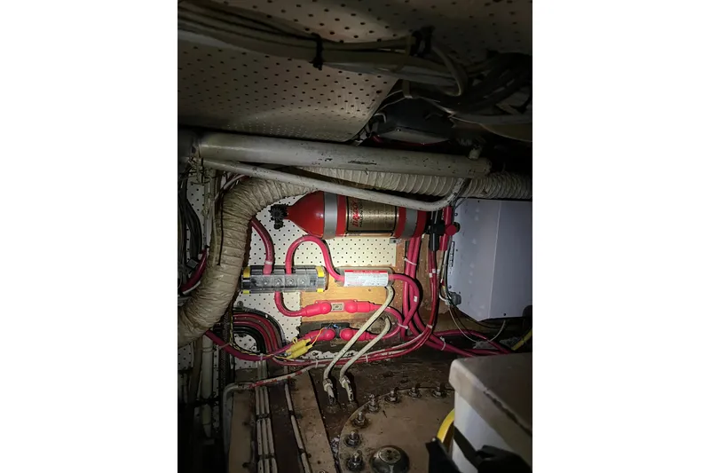 Slide: The Image of Engine room of 1980 Cheoy Lee 43 Pilot House with wiring and fire extinguisher. - 92