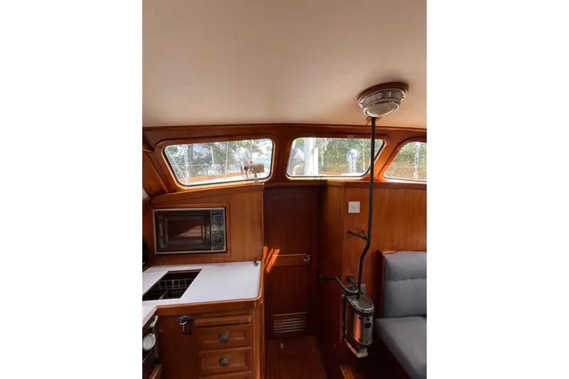 Slide: The Image of Interior of 1980 Cheoy Lee 43 Pilot House with wood paneling and windows. - 45