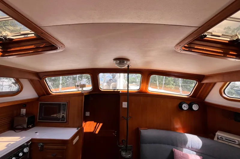 Slide: The Image of Interior of 1980 Cheoy Lee 43 Pilot House with wood paneling and large windows. - 40