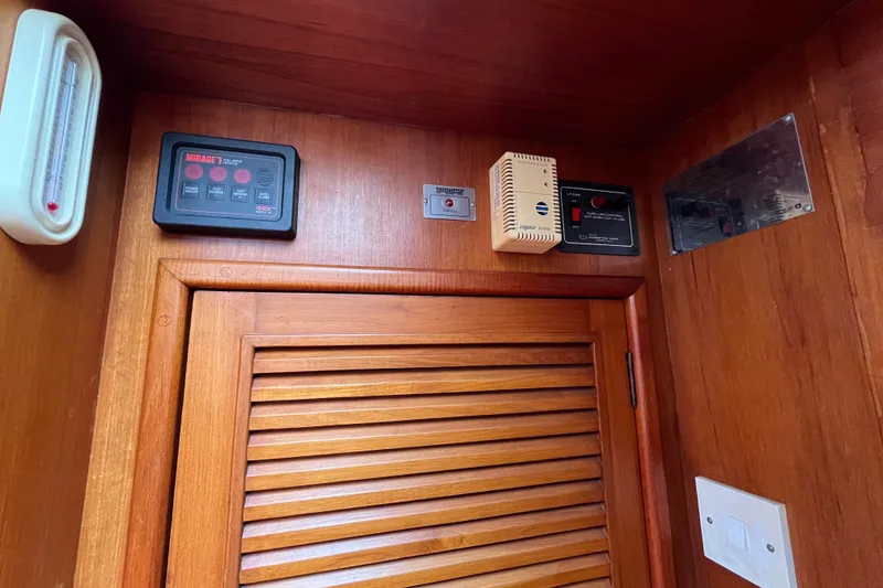 Slide: The Image of Interior of 1980 Cheoy Lee 43 Pilot House with control panels and wooden door. - 77