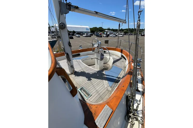 Slide: The Image of 1980 Cheoy Lee 43 Pilot House sailboat deck with wooden accents and steering wheel. - 28