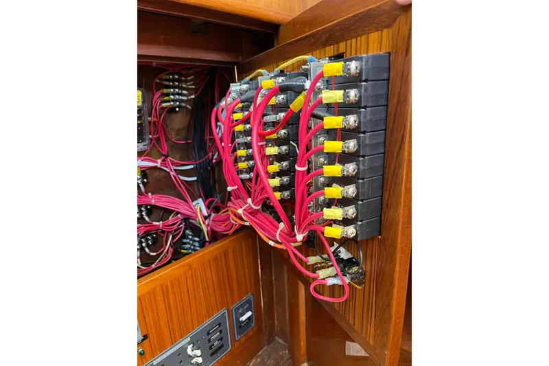 Slide: The Image of Electrical panel with red wires inside a 1980 Cheoy Lee 43 Pilot House boat. - 81