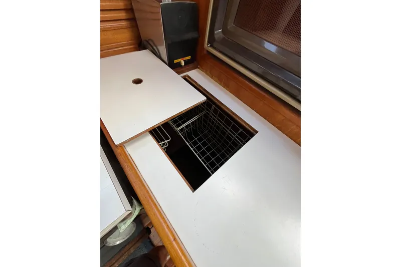 Slide: The Image of Interior of 1980 Cheoy Lee 43 Pilot House with open storage compartment. - 44