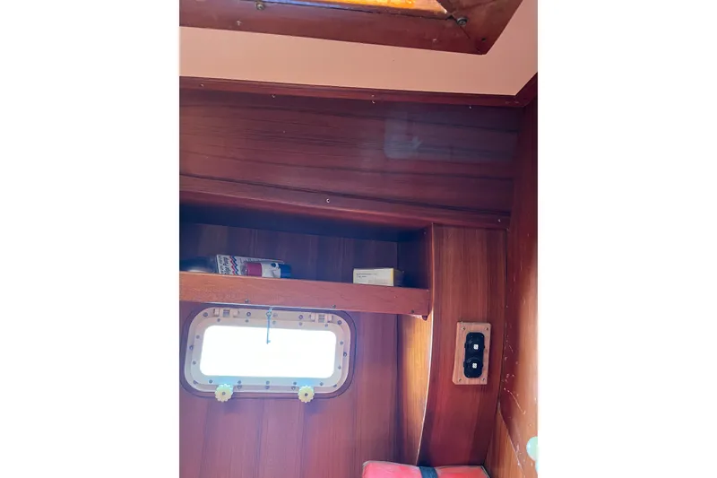 Slide: The Image of Interior of 1980 Cheoy Lee 43 Pilot House with wooden paneling and porthole. - 89