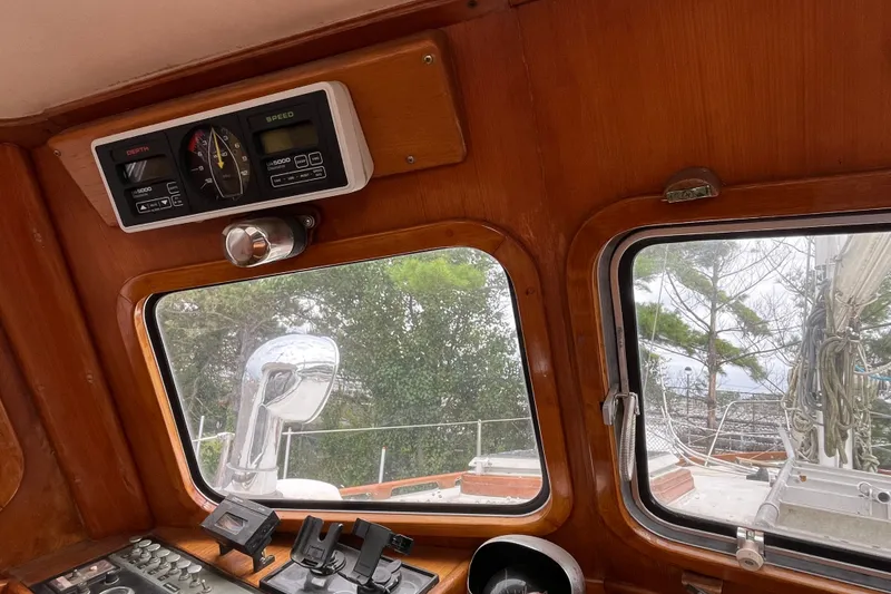 Slide: The Image of 1980 Cheoy Lee 43 Pilot House interior with navigation instruments and window view. - 34