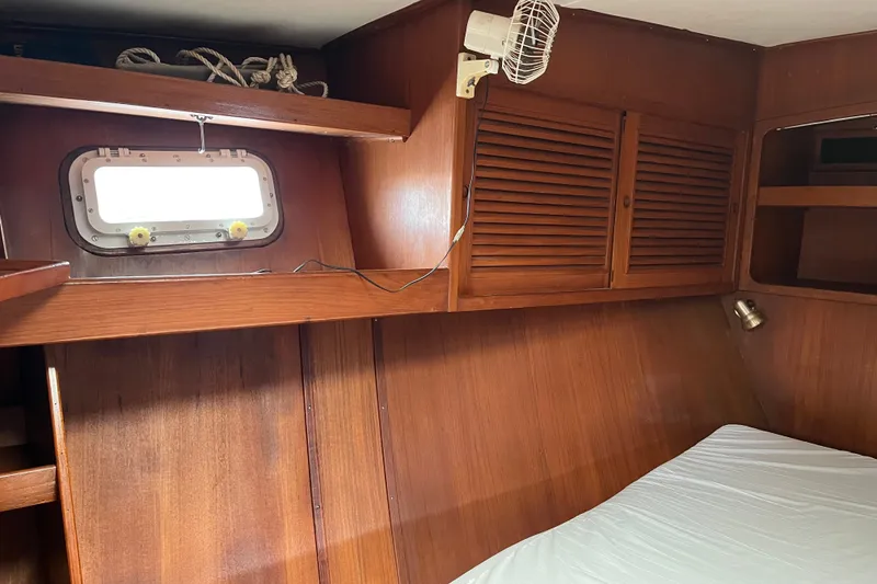 Slide: The Image of Interior of 1980 Cheoy Lee 43 Pilot House with wooden paneling and porthole. - 63